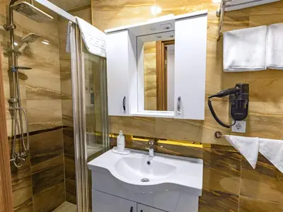 a bathroom with a sink and a shower at Quinnova Hotel in Istanbul