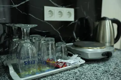a group of glass jars sitting on a counter next to a blender at BDK hotel in Istanbul