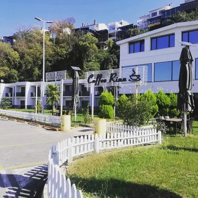 a white fence in front of a building at Rüya Otel Şile in Sile