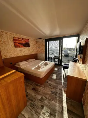 a bedroom with a bed and a large window at Rüya Otel Şile in Sile