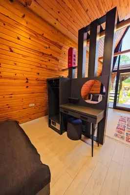 a living room with a couch and a desk at Kerpe Bungalov Hotel in Kocaeli