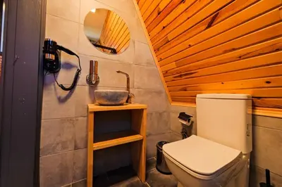 a bathroom with a toilet and a sink at Kerpe Bungalov Hotel in Kocaeli
