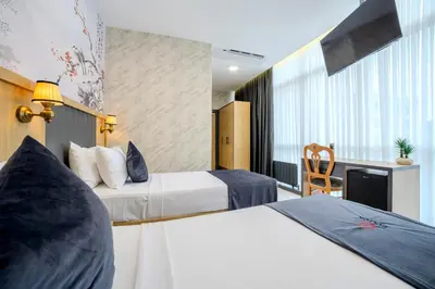 a hotel room with two beds and a kitchen at Bulton Hotel Airport in Arnavutköy