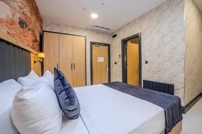 a bedroom with a large white bed in a room at Bulton Hotel Airport in Arnavutköy
