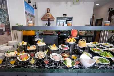 a buffet with many plates of food on a table at Bulton Hotel Airport in Arnavutköy