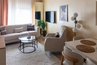 a living room with a couch and a table at Brand-New Stylish 2BR by the Coast in Yedikule in Istanbul