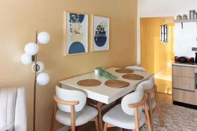 a dining room with a white table and chairs at Brand-New Stylish 2BR by the Coast in Yedikule in Istanbul