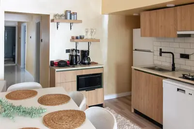 a kitchen with a table and chairs in a room at Brand-New Stylish 2BR by the Coast in Yedikule in Istanbul