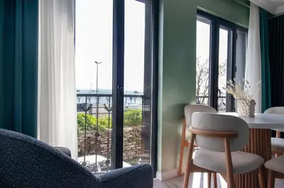 a room with a table and chairs and a large window at Modern & Stylish 2BR Haven by the Sea in Yedikule in Istanbul