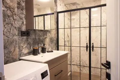 a bathroom with a sink and a shower at Classy 2BR Hideaway with Dazzling Panorama in Istanbul