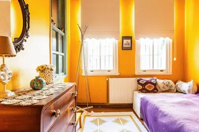 a bedroom with yellow walls and a bed and windows at Historic Balat 2BD2Bath Central House! #388 in Istanbul