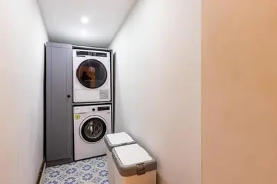 a washer and dryer in a corner of a bathroom at Historic Balat 2BD2Bath Central House! #388 in Istanbul