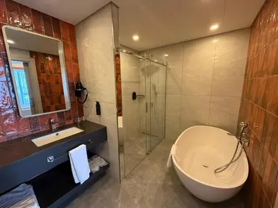 a bathroom with a tub and a sink and a shower at Sia Hotel Thermal & Spa in Nilüfer