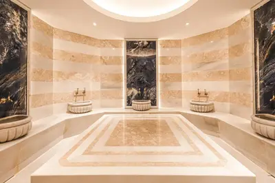 a large bathroom with three sinks and a large fountain at Sia Hotel Thermal & Spa in Nilüfer