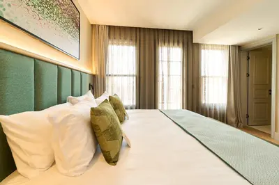 a bedroom with a large bed with white pillows at The Wings Hotels Pera in Istanbul