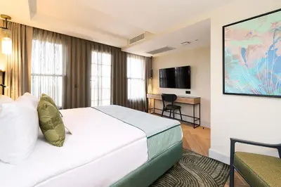 a hotel room with a bed and a desk at The Wings Hotels Pera in Istanbul