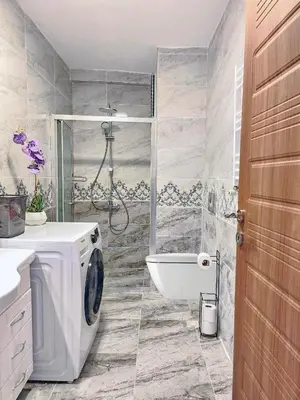 a bathroom with a washing machine and a shower at Excellent Apartments Pierre Loti in Istanbul
