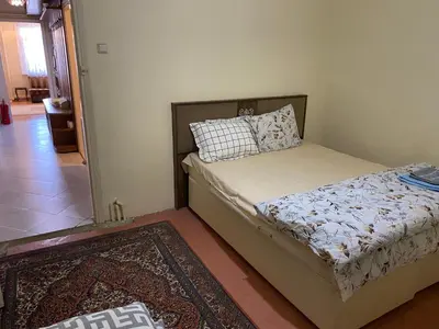 a bedroom with a bed and a rug at Spacious apartment very close to the tram in Istanbul