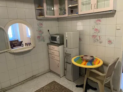 a small kitchen with a table and a refrigerator at Spacious apartment very close to the tram in Istanbul