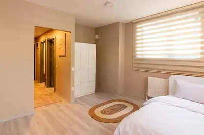 a bedroom with a bed and a window and a rug at Beautifully Designed 3BR Duplex in Prime Göktürk in Kemerburgaz