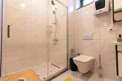 a bathroom with a shower and a toilet at Beautifully Designed 3BR Duplex in Prime Göktürk in Kemerburgaz