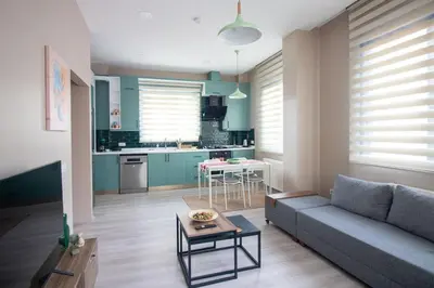 a living room with a couch and a kitchen at Beautifully Designed 3BR Duplex in Prime Göktürk in Kemerburgaz