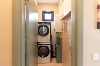 a laundry room with a washer and dryer in it at Modern 1BR with Elegant Design in Göktürk in Kemerburgaz