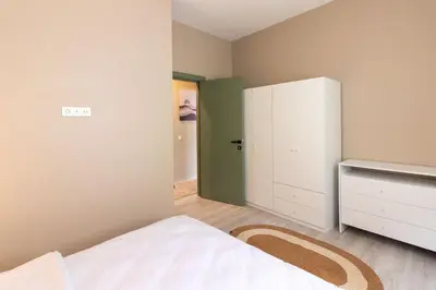 a bedroom with a bed and a closet and a door at Modern 1BR with Elegant Design in Göktürk in Kemerburgaz