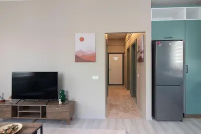 a living room with a tv and a refrigerator at Modern 1BR with Elegant Design in Göktürk in Kemerburgaz