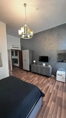 a bedroom with a bed and a tv and a chandelier at Echoloft İstanbul- Nişantaşı in Istanbul