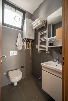 a small bathroom with a toilet and a sink at House with balcony in Galata 2 in Istanbul