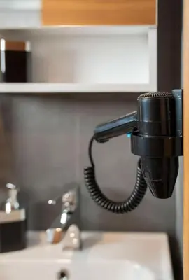 a black phone hanging on a wall above a sink at House with balcony in Galata 2 in Istanbul