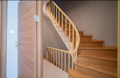 a wooden spiral staircase in a home with wooden floors at House with balcony in Galata 2 in Istanbul