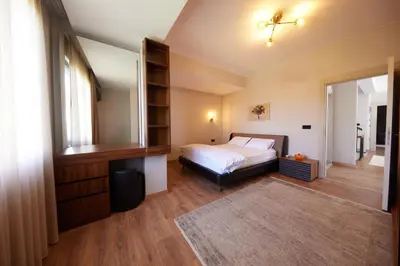 a bedroom with a bed and a book shelf at Andalus Villas Lake View NO ALCOHOL ALLOWED with Heated Pool in Sakarya