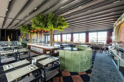 a restaurant with tables and chairs and a large window at Hotel Yigitalp Istanbul in Istanbul