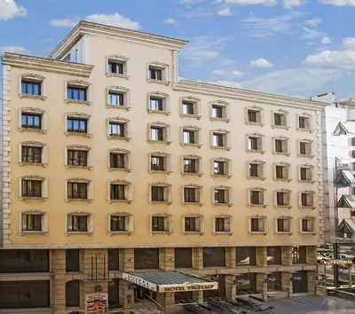 a large yellow building with many windows at Hotel Yigitalp Istanbul in Istanbul