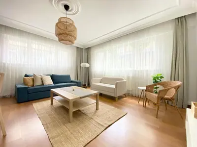 a living room with a blue couch and a table at Near Nişantasi & Stylish No1 in Istanbul