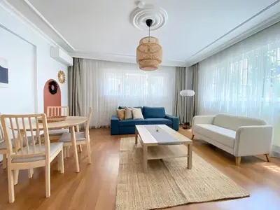 a living room with a blue couch and a table at Near Nişantasi & Stylish No1 in Istanbul