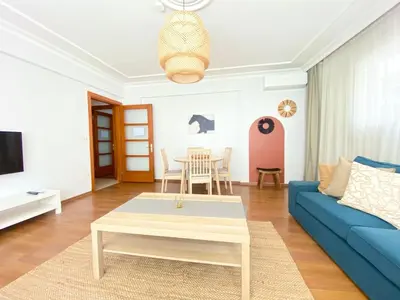 a living room with a blue couch and a table at Near Nişantasi & Stylish No1 in Istanbul