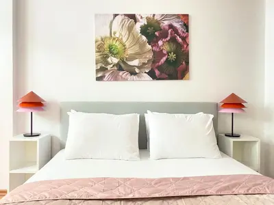 a bedroom with a bed with a painting on the wall at Near Nişantasi & Stylish No1 in Istanbul