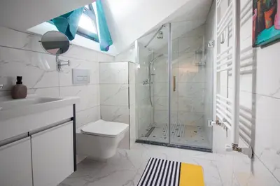 a bathroom with a shower and a toilet and a sink at Göktürk's Finest 2BR Stylish, Spacious & Prime in Kemerburgaz