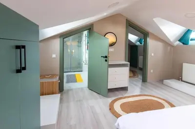 a bedroom with a green door and a bathroom at Göktürk's Finest 2BR Stylish, Spacious & Prime in Kemerburgaz