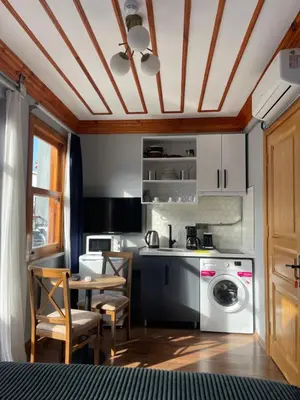 a kitchen with a washing machine and a table at Soil balat in Istanbul
