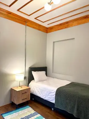 a bedroom with a bed and a table with a lamp at Soil balat in Istanbul