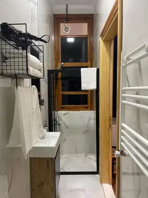 a bathroom with a sink and a mirror and a television at Soil balat in Istanbul
