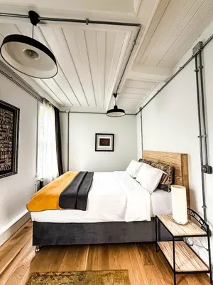 a bedroom with a large bed and a wooden floor at Sel Maison in Istanbul