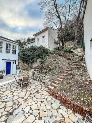 a stone patio with a table and chairs in front of a house at Sel Maison in Istanbul
