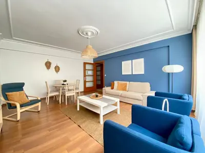a living room with blue walls and a couch and a table at City Center 3 Bedroom Flat - No4 in Istanbul