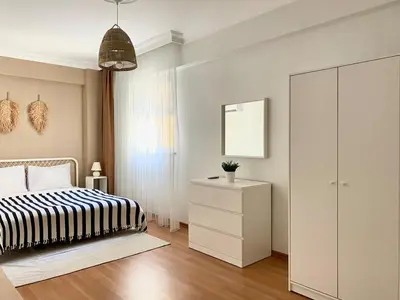 a bedroom with a bed and a dresser and a mirror at City Center 3 Bedroom Flat - No4 in Istanbul