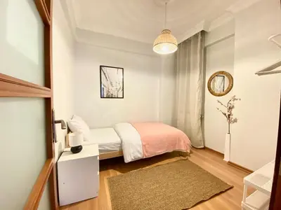 a small bedroom with a bed and a mirror at City Center 3 Bedroom Flat - No4 in Istanbul